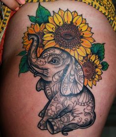 an elephant with sunflowers on its back