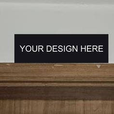 a black sign that says your design here