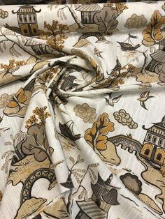 an image of a white fabric with yellow and brown designs