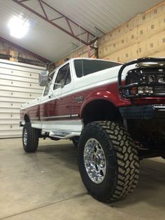 a red and white truck parked in a garage