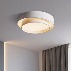 a round light fixture in a white room