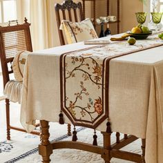 a dining room table covered with a white table cloth