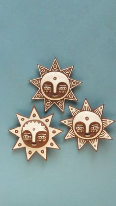 three sun and moon brooches on a blue background