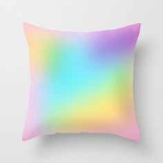 a pink and blue ombreed pillow on a white wall with a black frame