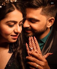 a man and woman standing next to each other with their hands on their chests