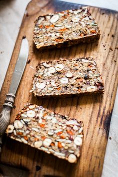 three slices of granola on a wooden cutting board