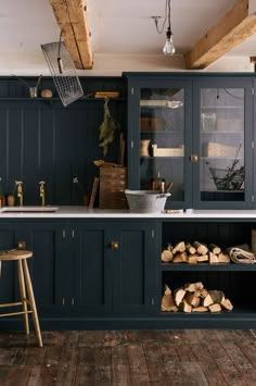 a kitchen with wooden floors and blue cabinets