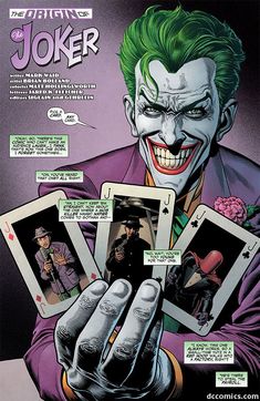 the joker is holding up two cards and pointing them at something in front of him