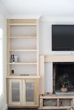 a living room with a fireplace and entertainment center