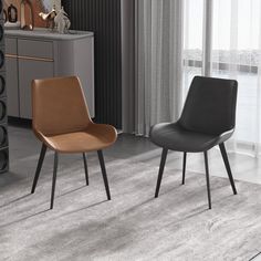 two brown chairs sitting next to each other on top of a gray carpeted floor