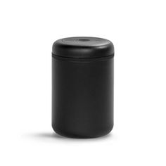 a black canister sitting on top of a white surface