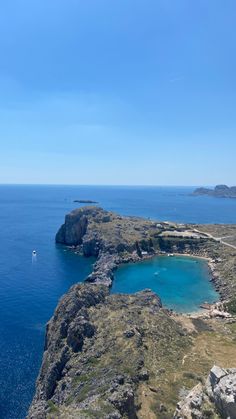 the blue water is surrounded by rocky cliffs