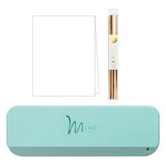 the mint green box contains two pens and a white paper with gold foil on it