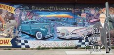 a man is standing in front of a wall with an old car painted on it