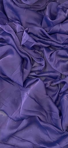 an image of purple fabric that is very soft and drapy in the wind