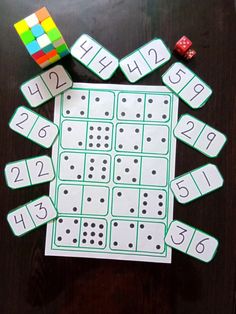 a table topped with lots of dices and numbers