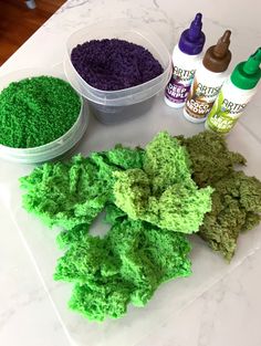 green and purple dyes sitting on top of a counter