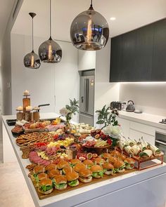 a large buffet with lots of food on it's counter top in a kitchen