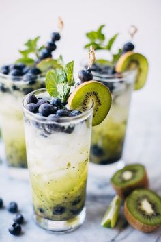 two glasses filled with blueberries and kiwi