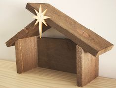 a small wooden house with a star on top