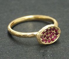 a close up of a gold ring with red stones on the inside and outside of it