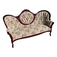 an old fashioned couch with floral upholstered fabric on the back and armrests