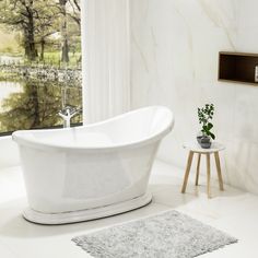 a white bath tub sitting next to a window