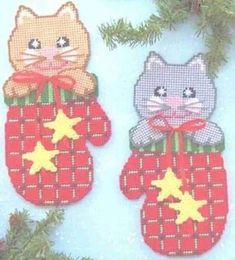 two christmas stockings decorated with cats and stars