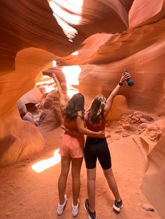 two young women are taking pictures in the slot