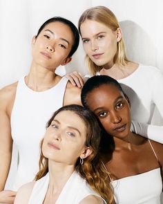 three models pose for the camera with their arms around each other