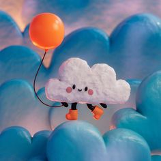 a cloud floating in the air with a balloon attached to it