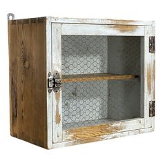 an old wooden cabinet with chicken wire in it