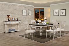 a dining room table with white chairs in front of a brick wall and wooden floor