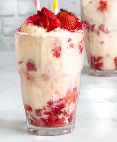 two glasses filled with ice cream and strawberries