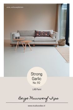 a living room with a white couch and wooden table in front of the sofa is an advertisement for strong garlic no 9