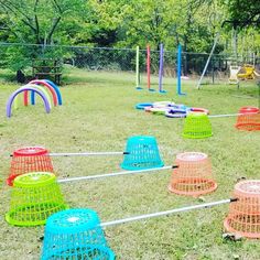 there are many different colored frisbees in the yard