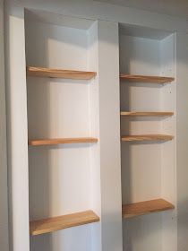 two empty shelves in the corner of a room