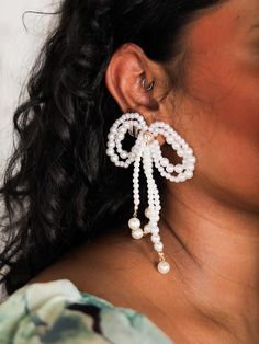 Add a touch of elegance to any outfit with The Pearl Bow Earrings! The large pearl bows make them the perfect accessory for holiday events or for any bride-to-be. Details Post Back Pearl Bows Dangles Lead & Nickel Compliant Pearl Wedding Jewelry, Bridal Statement Earrings, Pearl Bow, Holiday Events, Earrings Pearl, Bow Earrings, The Pearl, Backyard Wedding, How To Make Bows