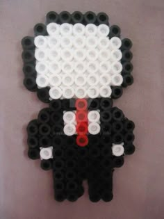 a black and white sheep with a red tie on it's head is made out of legos