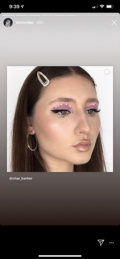 a woman with long brown hair and purple eyeshadow