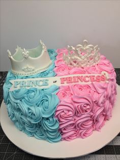 there is a cake decorated with pink, blue and white frosting