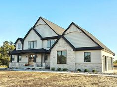 Exterior home house exterior stone smartside shakes siding front door neutral exterior White Brick Dark Trim, Warm Exterior House Color Schemes, Light Brick And Siding Exterior, Creamy White And Black House Exterior, Cream Hardy Board House, Home Exterior Brick And Siding, Black Accent Exterior House, Beige And Dark Brown House Exterior, Exterior Home Finishes