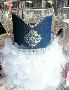 a tiara sitting on top of a table next to some glasses and silverware