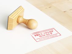 a rubber stamp on top of a piece of paper next to a wooden stamper