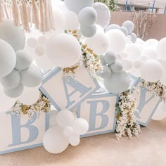 baby shower decorations and balloons on display at a party