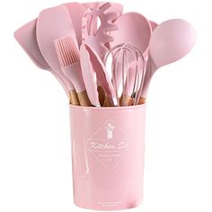 a cup filled with pink kitchen utensils