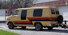 an old yellow van parked in front of a building