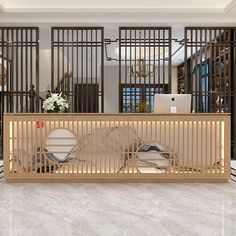 a reception area with wooden partitions and white marble flooring in front of a laptop on a desk