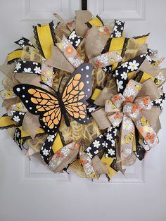 a yellow and black wreath with a butterfly on it