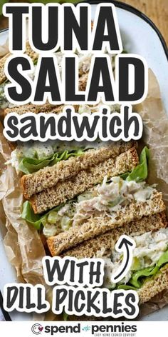 tuna salad sandwich with dill pickles on toasted bread and lettuce